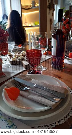 Served Table In Restaurant. White Plate Knife Fork And Wine Glasses. Romantic Interior Concept