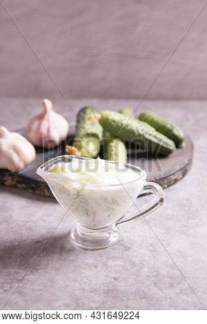 On A Concrete Background, Traditional Greek Tzatziki Sauce Made Of Cucumbers, Yogurt And Garlic. Med