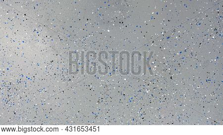 A Freshly Painted With A Gray Epoxy Finish Sprinkled With Blue, Black And White Plastic Chips.