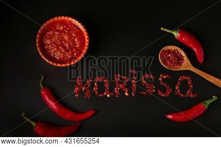 Hot Sauce Paste Harissa With Chili Pepper On Dark Background, Tunisia And Arabic Cuisine, Word Haris