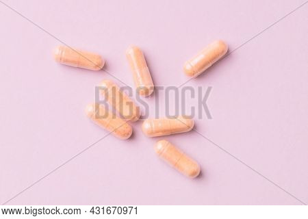 Goji Berry (wolfberry) Capsules. Immune System Support. Dietary Supplement On Pink Paper Background.