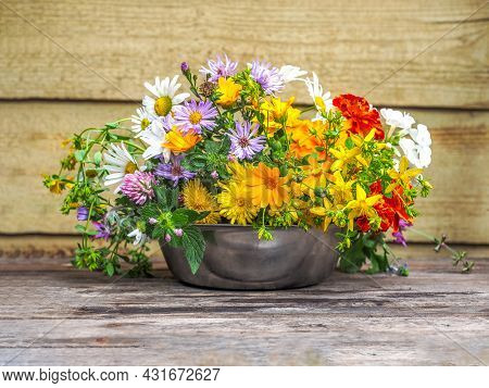 A Variegated Bouquet Of Summer Wildflowers In A Metal Cup Close-up