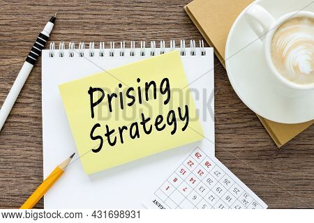 Prising Strategy . Business Concept. Text On Sticker On White Paper Near White Cup Of Coffee