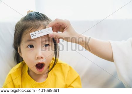Adorable Kid Toddler Show Her Result Test That Holding By Parent Hand, Rapid Test Kit That Appear Ne