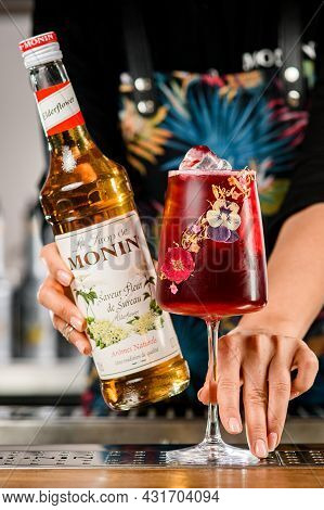Ukraine, Kyiv - March 12, 2021: Bartender Hand Is Holding Bottle Of Saveur Fleur De Sureau Syrup And