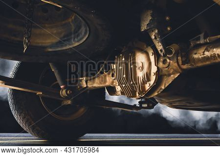 Rear Drive Shaft With Dirty Of Pickup Truck On The Asphalt Road And Smoke At Night