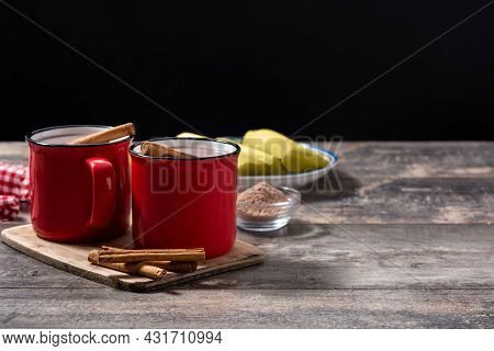 Traditional Mexican Chocolate Atole Drink On Wooden Table. Copy Space