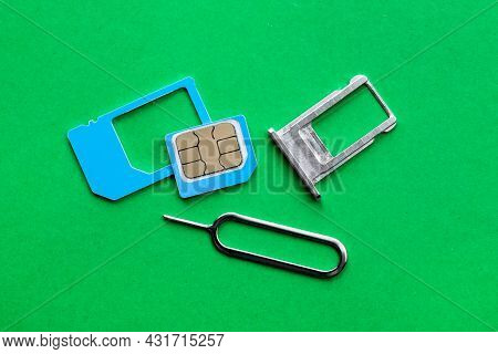 Sim Card, Tray And Ejector On Green Background, Flat Lay