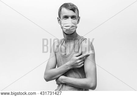 Man Getting Covid Vaccinated. Person Wearing Face Mask. Happy Man Showing His Arm With Bandage After