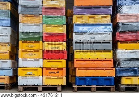 Sassnitz, Germany, August 20, 2020: Stacks Of Colorful Plastic Boxes Delivered From Fishermen Of Dif