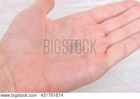 A Micro Sim Card On A Palm, Hand, Person Holding A Simcard