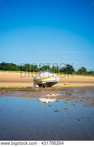 A Motorboat Laying On The Beach Plage De La Loge At Lowtide On A Sunny Summertime On The Isle Of île