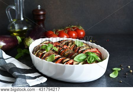 Vegetable Ratatouille On A Black Concrete Background.
Baked Vegetables On The Kitchen Table.
