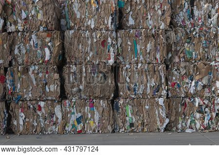 Cardboard And Paper Pressed Into Cubes And Stacked For Recycling