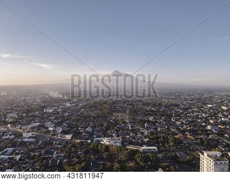 Aerial View Of Sunset Mount Merapi And Yogyakarta City, Indonesia. City With Mountain Background Vie