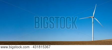 Wind turbines sunny summer autumn mountain landsape. Green ecological power energy generation. Wind farm eco field