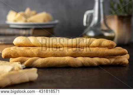 Grissini sticks. Traditional italian bread sticks on black table.
