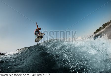 Great View Of The Splashing Wave And Man Jumping Over It On Foilboard