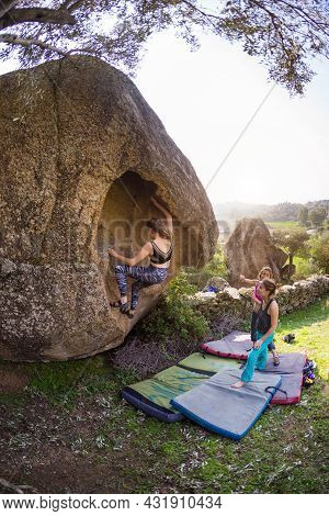 Friends Go In For Sports In Nature, Bouldering On Rocks, Girl Climbs A Big Stone, Woman Is Belayng P