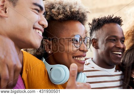 Group Of People, Smiling And Happy To Be Together. A Latina Girl Hugging With Her Friends, An Africa