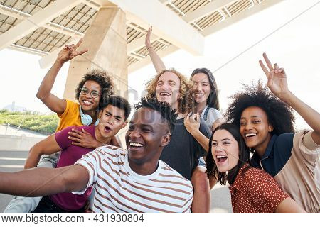 Group Of Friends Taking A Selfie And Having Fun In The City. Friendly Interracial Young People. Conc