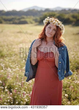 Red-haired Woman On Field On Summer Evening