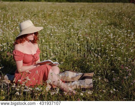 Red-haired Woman On Field Summer Evening