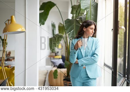 Young Business Woman Enjoying Relaxing With Her Morning Coffee Or Tea, Looking Out The Window. Beaut