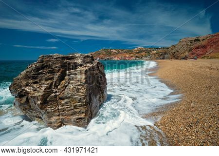 Rocks on Paleochori beach and waves of Aegean sea, Milos island, Cyclades, Greece. Slow motion