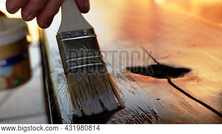 Applying Varnish To The Surface Of Vintage Wooden Furniture, Close-up Of A Brush Applying Varnish To