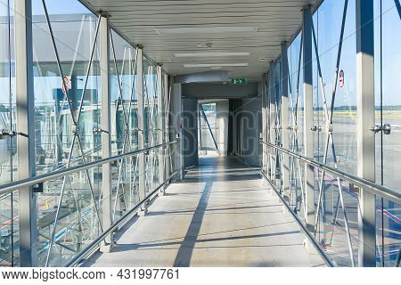 Passenger Boarding Bridge Pbb To Board Airplane. Boarding Gate Entrance To Train Station From Via Sk