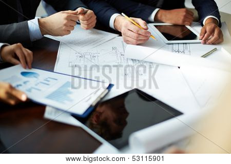 Image of human hands during discussion at meeting 