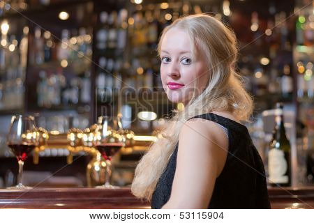 Beautiful Woman Seated At A Bar Counter