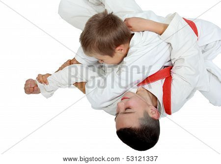 Athlete on a white background with a red belt makes a reception