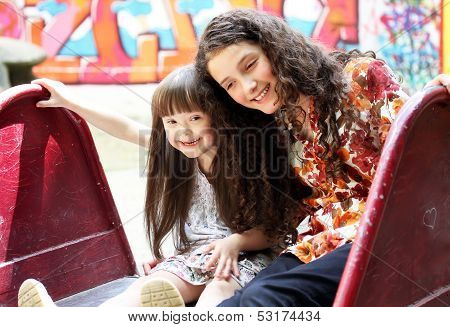 Portrait Of Beautiful Young Girls On The Playground.