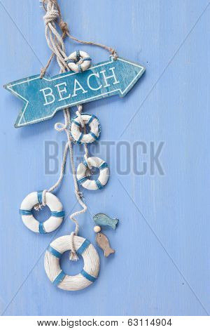 Blue Background With A Signpost To The Beach