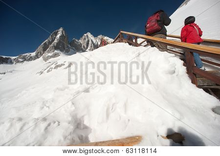Wooden Stair And Traveler On Jade Dragon Snow Mountain,lijiang,yunnan,southwestern China.