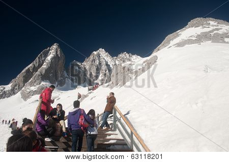 Wooden Stair And Traveler On Jade Dragon Snow Mountain,lijiang,yunnan,southwestern China.