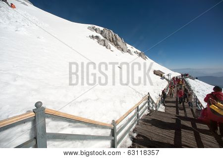Wooden Stair And Traveler On Jade Dragon Snow Mountain,lijiang,yunnan,southwestern China.