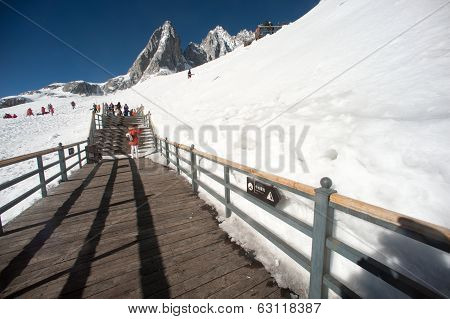 Wooden Stair And Traveler On Jade Dragon Snow Mountain,lijiang,yunan,southwestern China.
