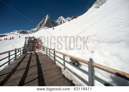 Wooden Stair And Traveler On Jade Dragon Snow Mountain,lijiang,yunnan,southwestern China.