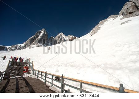 Wooden Stair And Traveler On Jade Dragon Snow Mountain,lijiang,yunnan,southwestern China.