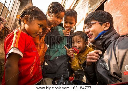 KATHMANDU, NEPAL - DEC 19, 2013: Unidentified local children near their homes in a poor area of the city. The caste system is still intact today but the rules are not as rigid as they were in the past