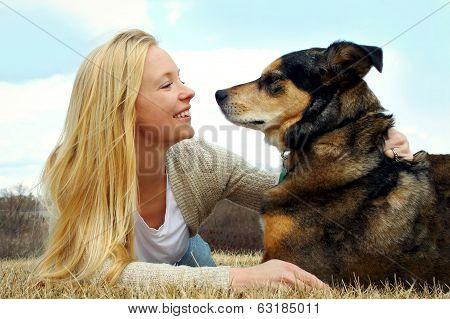 Woman Petting Her German Shepherd Dog Outside