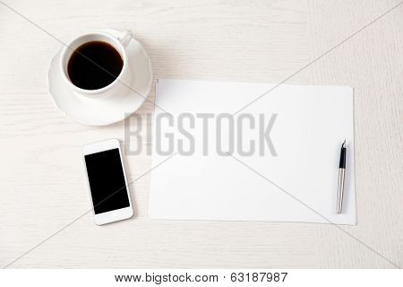 Blank paper and pen on wooden table