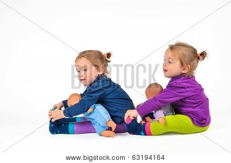 Twin Babies Exercising With Dolls