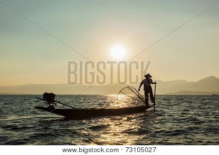 Myanmar travel attraction landmark - Traditional Burmese fisherman at Inle lake, Myanmar famous for their distinctive one legged rowing style