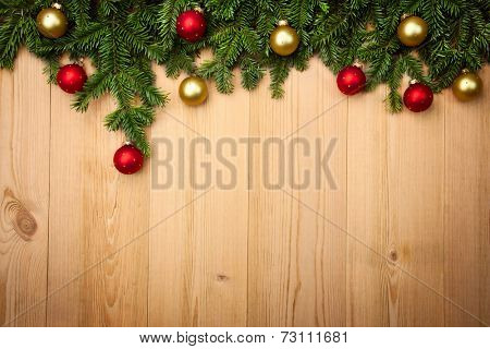 Christmas background with fresh fir-tree and  baubles on wood - horizontal