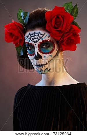 Woman in Halloween makeup - mexican Santa Muerte mask.
