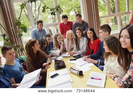 happy young teens group in school on chemisty lessons and library education